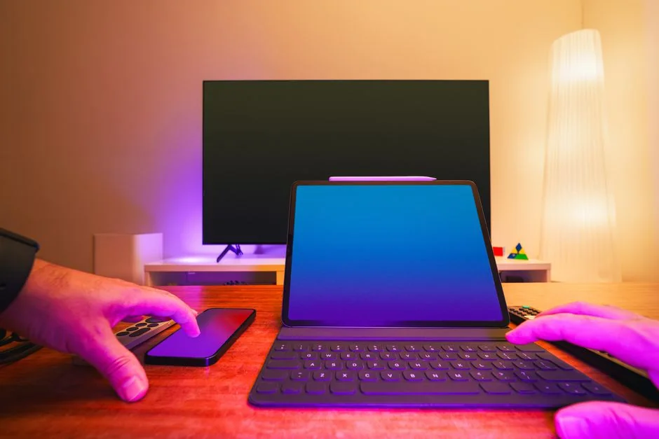 A modern workspace featuring dual computer monitors displaying web design projects, emphasizing technology and productivity.